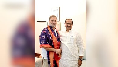 TPCC Chief with Rahul Gandhi discussing BC reservation in women's quota at an event.