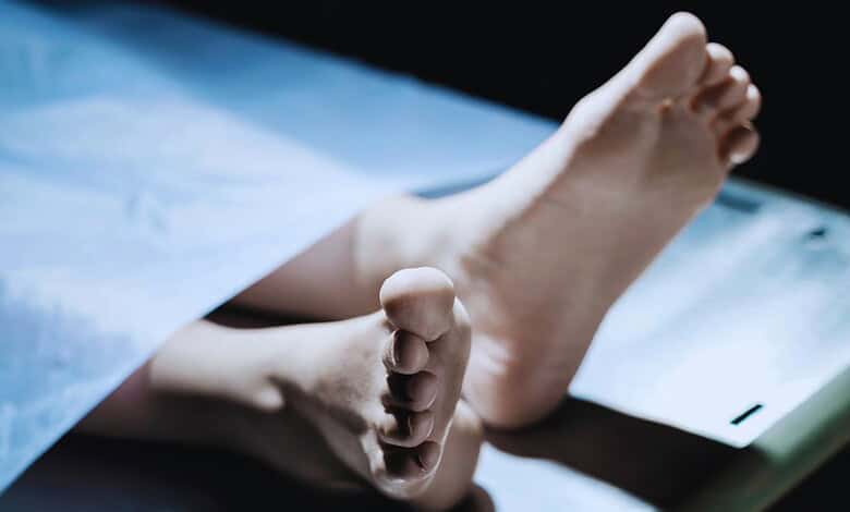 Image shows the lifeless body of a young boy on a hospital bed, related to a murder case