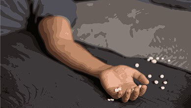 Person lying on the floor with pills scattered around, indicating a possible overdose emergency.