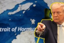 US President Donald Trump gestures beside a map of the Strait of Hormuz.