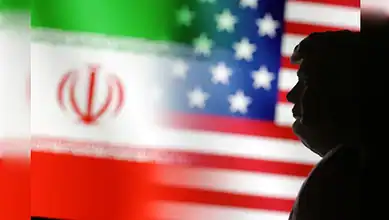 Silhouette of a person in front of Iran and US flags, highlighting rising geopolitical tensions.