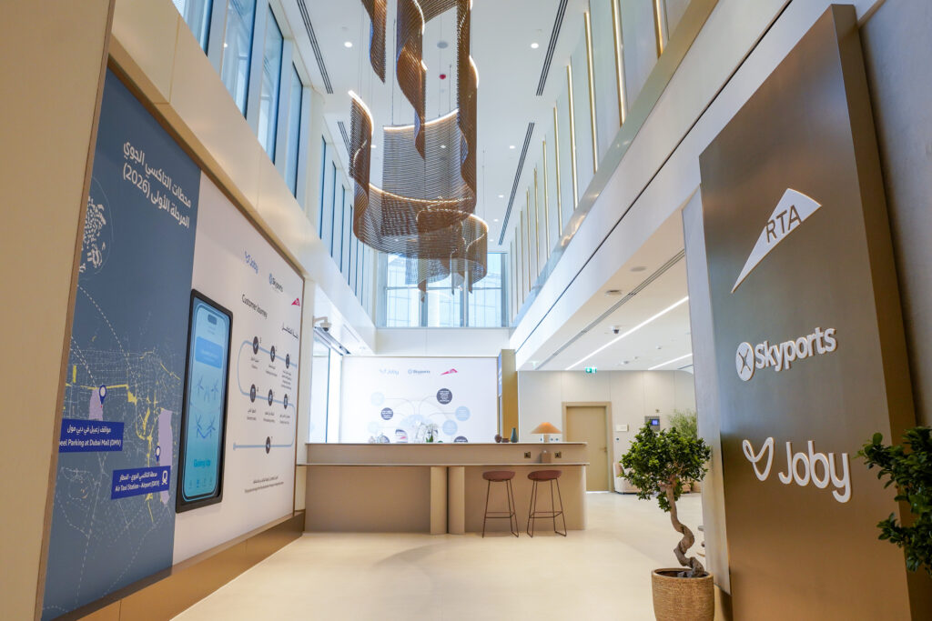 Interior of Dubai air taxi station showing reception and digital display panels.
