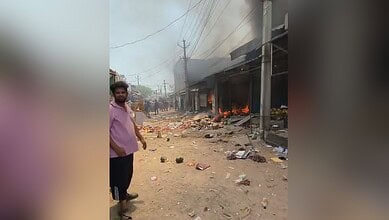 Fire burning at scrap warehouse in Hyderabad's Balapur area, smoke rising.