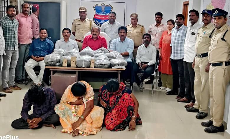 Group of police officers and civilians with confiscated items in an office setting.
