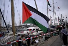 Global Sumud Flotilla boats docked in Barcelona with Palestinian flags ahead of Gaza-bound mission.