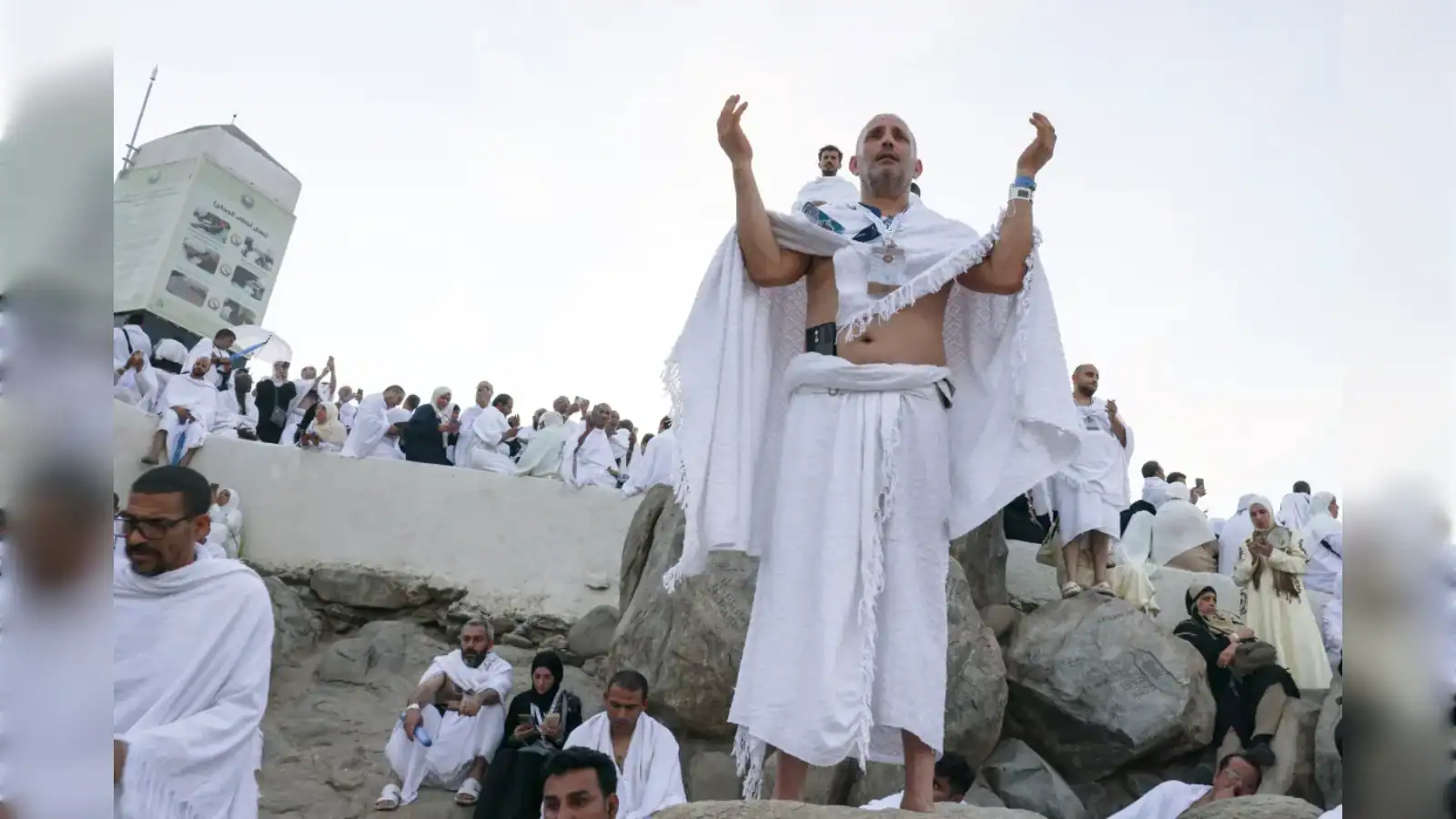 Devotees celebrating Holi festival on the beach with vibrant colours and traditional attire.