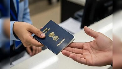 Handing over a passport at a service counter, representing Alhind's new UAE contract for passport and vis.