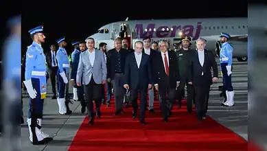 Iranian Foreign Minister Abbas Araghchi arrives at Nur Khan Airbase in Rawalpindi, Pakistan, walking on a red carpet beside a Meraj aircraft as honour guards stand at attention.