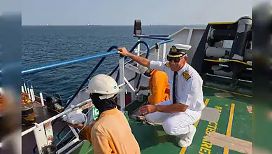 Iraqi captain supervises crew on oil tanker deck in Gulf of Oman.
