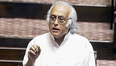 Indian politician speaking passionately, raising hand during a debate on Gaza conflict.