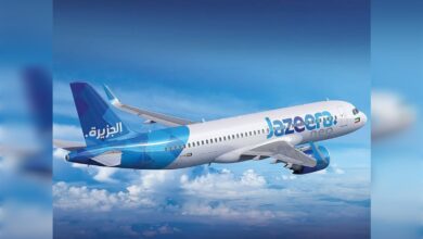 Jazeera Airways aircraft flying above clouds.