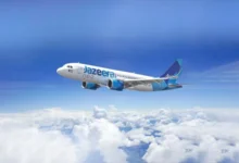 Jazeera Airways aircraft flying above clouds