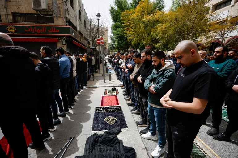Worshippers praying on a street in Jerusalem as access to Al-Aqsa Mosque remains restricted.