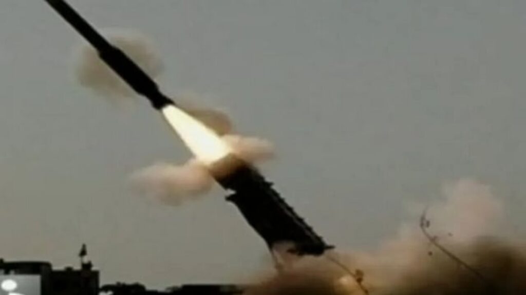 Air defence system intercepting a missile mid-air during an attack.