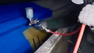 A person uses spray equipment to paint a missile blue in footage shared online.