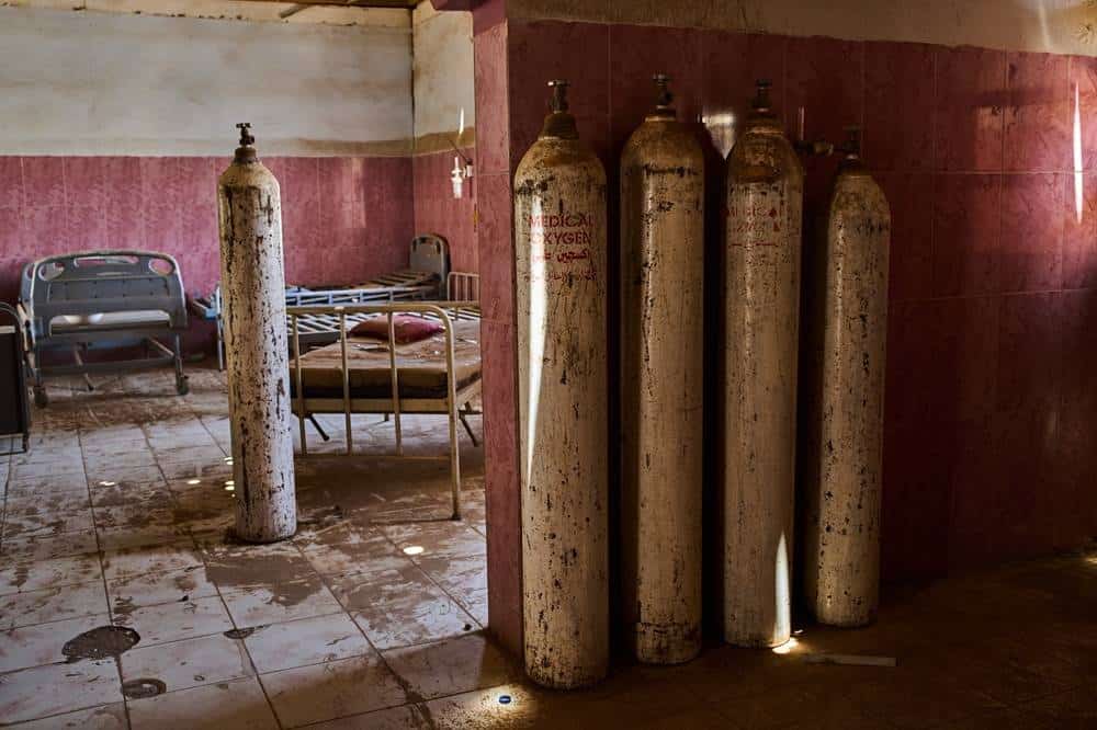 Oxygen cylinders stand beside hospital beds in a war-damaged ward at Al Shaabi Hospital in Khartoum.