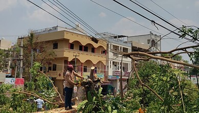 Fallen tree branches and power lines caused by unseasonal rain, leading to power outages and water supply disruptions in Hyderabad.
