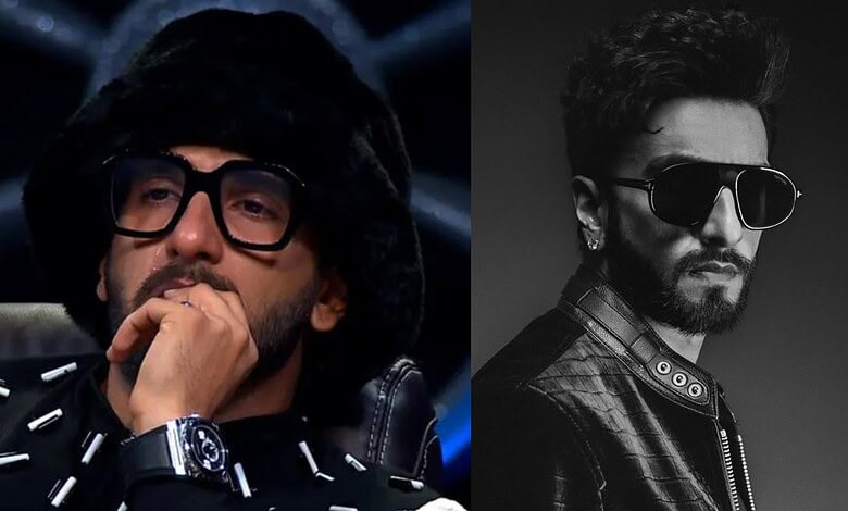 Ranveer Singh wearing glasses and a hat, looking thoughtful in a dark setting.