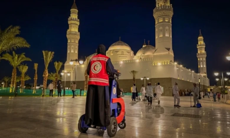 Saudi Red Crescent responder at Quba Mosque in Madinah at night.