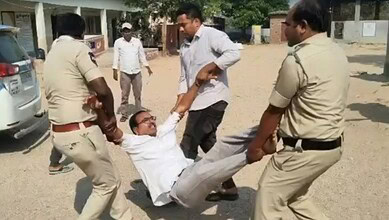 Ex-Sarpanch being forcibly removed during protest over Rs 22 lakh dues in Telangana.