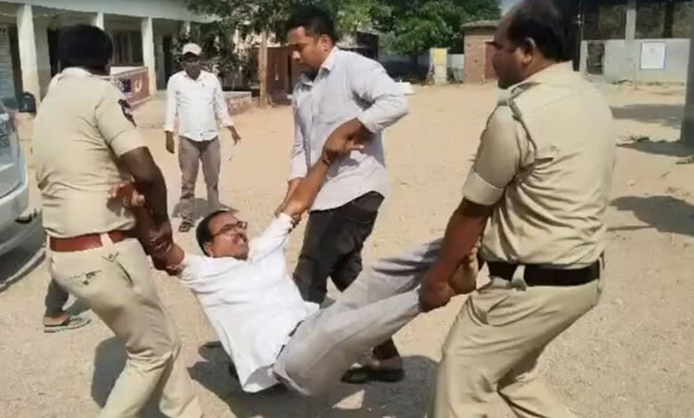 Ex-Sarpanch being forcibly removed during protest over Rs 22 lakh dues in Telangana.