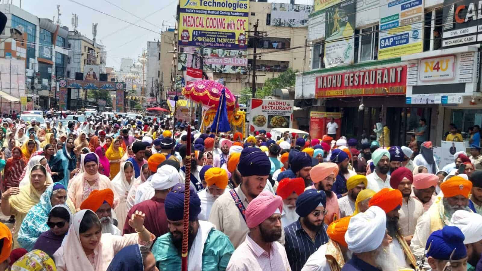 Large crowd of Sikhs celebrating Khalsa Foundation Day with devotion in Hyderabad, colourful turbans and.