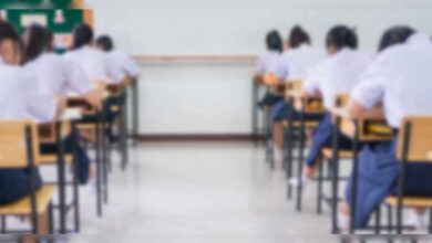 Students seated in a classroom taking an examination.