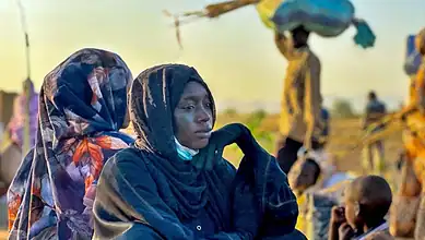 A woman in Sudan looks worried as the ongoing war causes suffering and displacement among civilians.