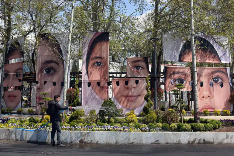 Large portraits of children killed in the Minab strike displayed along a Tehran roadside.