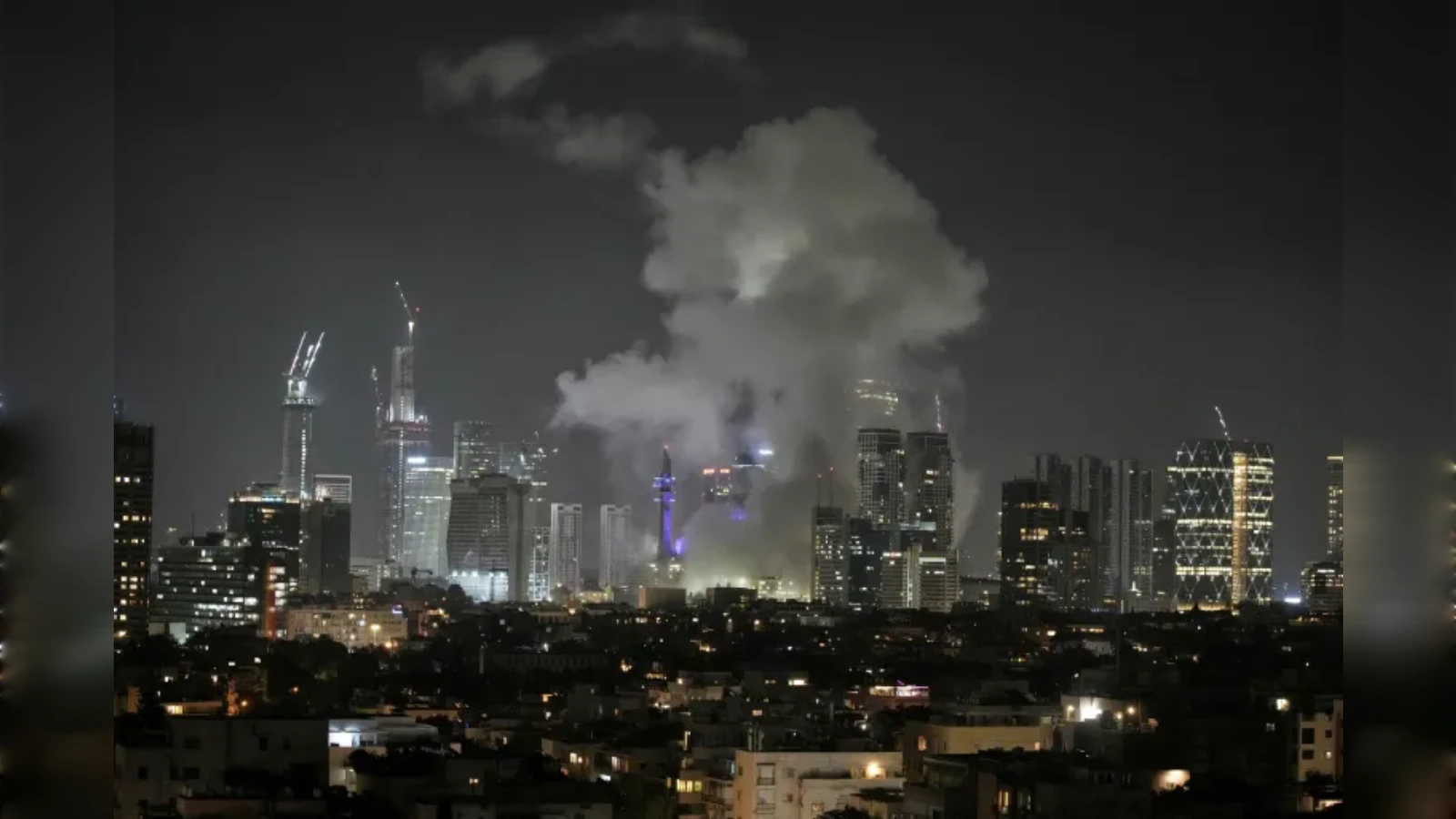 Smoke rising over Tel Aviv skyline after missile attack, June 13, 2025.