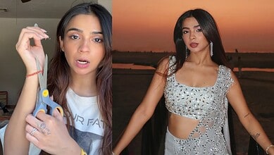 Young woman with long dark hair wearing a silver crop top, posing outdoors at sunset.