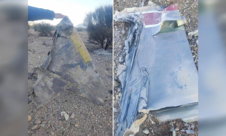 Wreckage of a downed aircraft with visible metal fragments and markings, reportedly from a US jet in Iran.