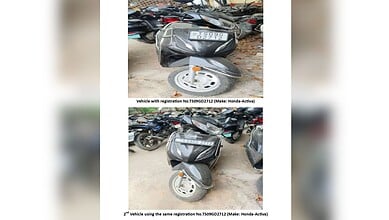 An image showing a motorcycle with a fake registration plate, used by a man in Hyderabad to evade traffic.