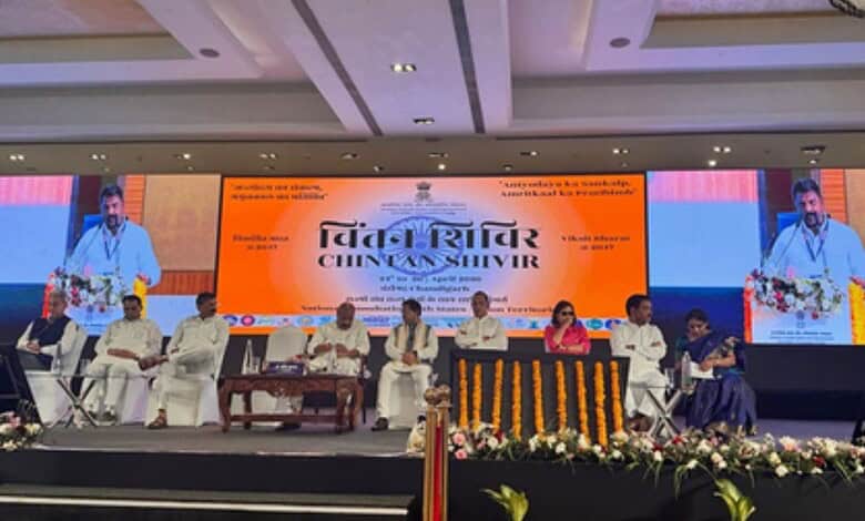 Telangana welfare model showcased at a conference with officials on stage.