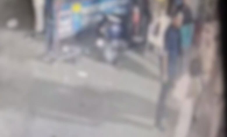 Emergency responders and bystanders at a traffic accident scene in a busy city street.