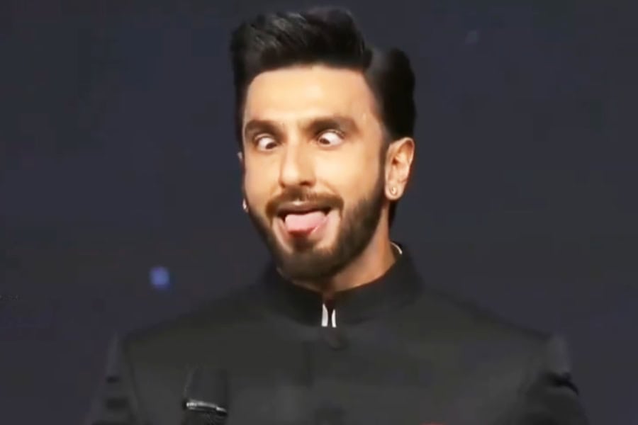 Indian TV judge making a humorous face during a talent show performance.