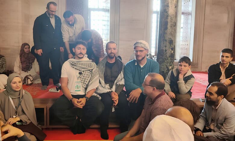 Diverse group of people engaging in a discussion in an elegant indoor setting with wooden walls and large.
