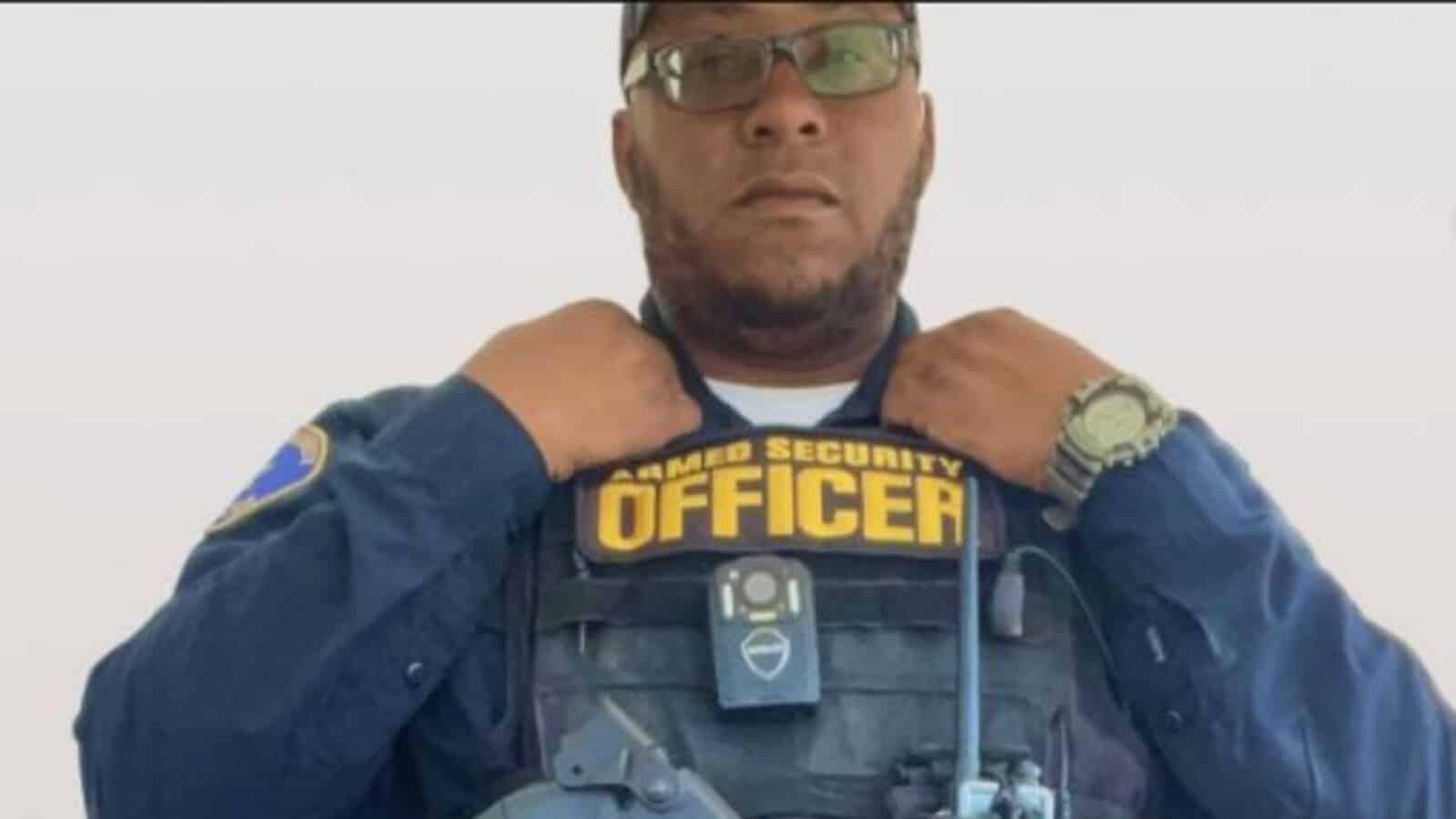 A security officer adjusting his uniform with