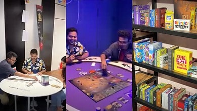 Engaging group playing board game in a modern gaming room with shelves of board games and books.