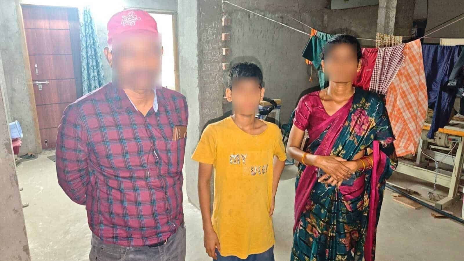 Family members standing together in a laundry area with clothes hanging to dry.