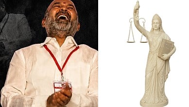 Man laughing joyfully at a legal event, with a statue of Lady Justice holding scales and a sword in the b.