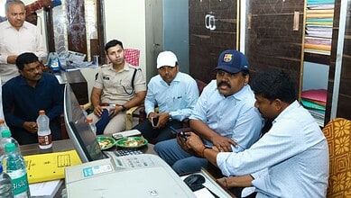 Officials discuss paddy transportation improvements at Nalgonda rice mill.