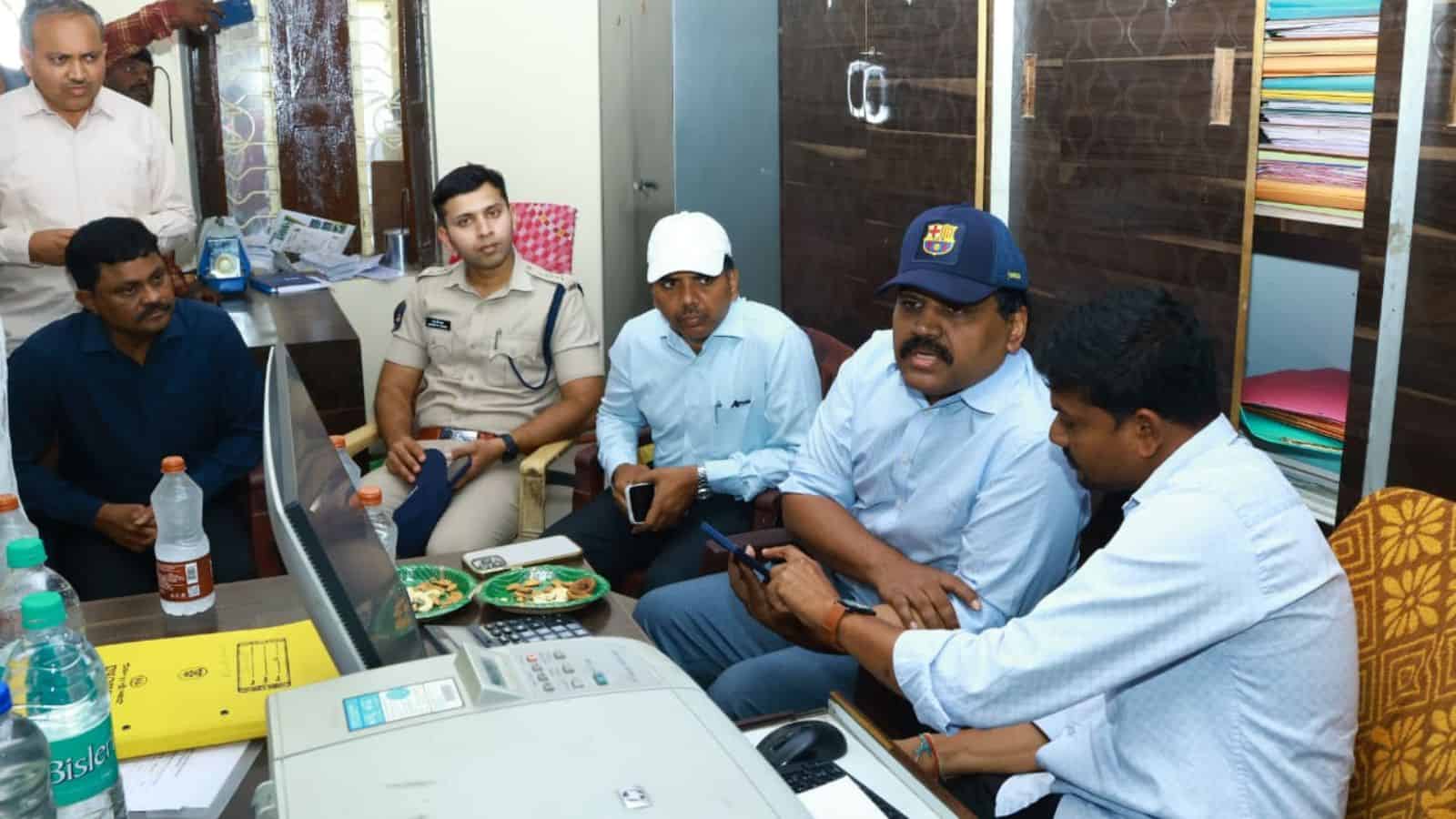 Officials discuss paddy transportation improvements at Nalgonda rice mill.