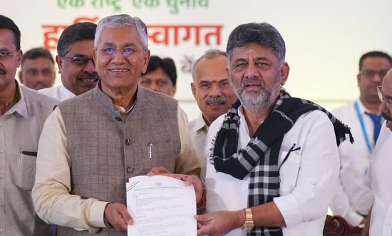 Prominent Indian officials at a public event, exchanging documents and engaging with attendees.