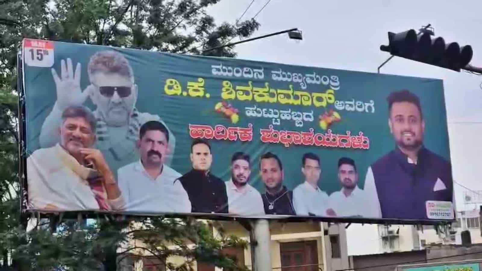 A political billboard featuring multiple candidates and a prominent leader with sunglasses, promoting a l.