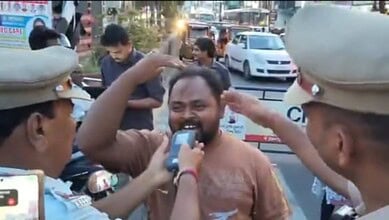 A man happily interacts with police officers during a street celebration, capturing a joyful moment amids.