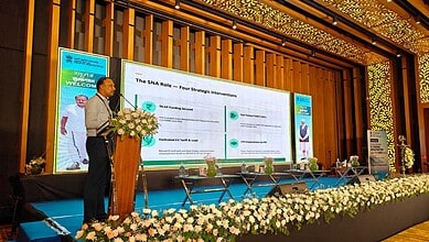 An official presenting at a conference on Telangana's 91K EV registrations in 2025–26, highlighting progr.