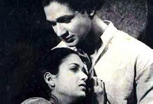 Black and white image of a man and woman in a close, emotional moment, highlighting cultural or historica.