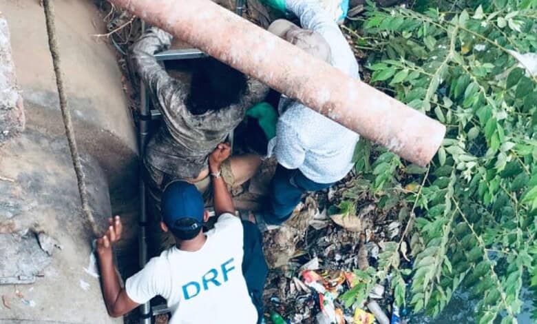 The image shows HYDRAA's DRF team rescuing a woman from the Musi River in Golnaka on Saturday, May 9, 2026.