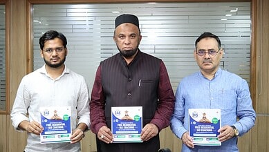 Three men holding educational campaign flyers at a formal event in an office setting.